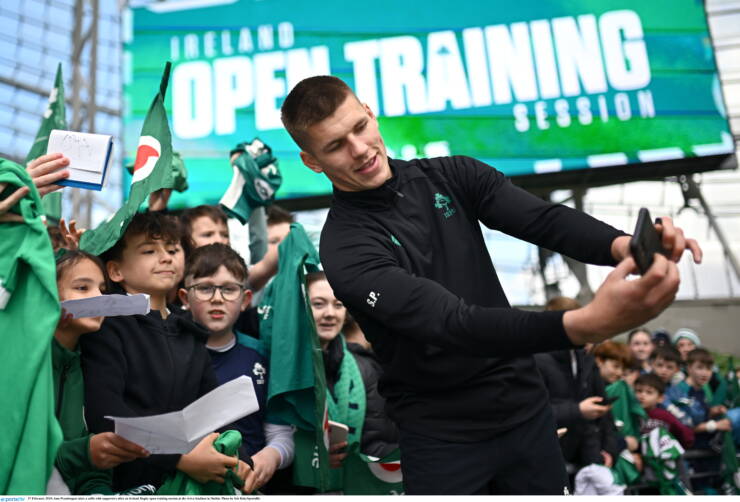 27 February 2025; Sam Prendergast takes a selfie with supporters after an Ireland Rugby open training session at the Aviva Stadium in Dublin. Photo by Seb Daly/Sportsfile