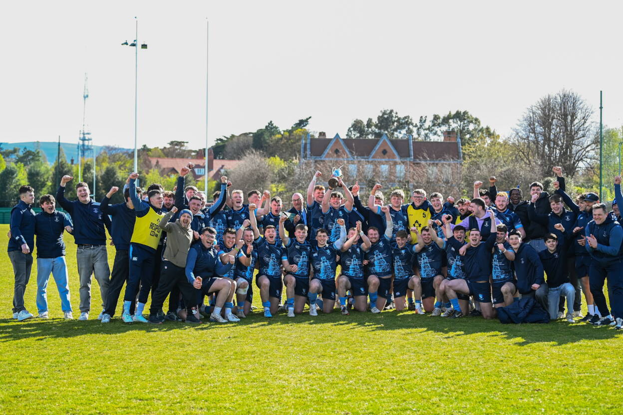 The victorious MU Barnhall players and coaches celebrate with the Fraser McMullen Cup