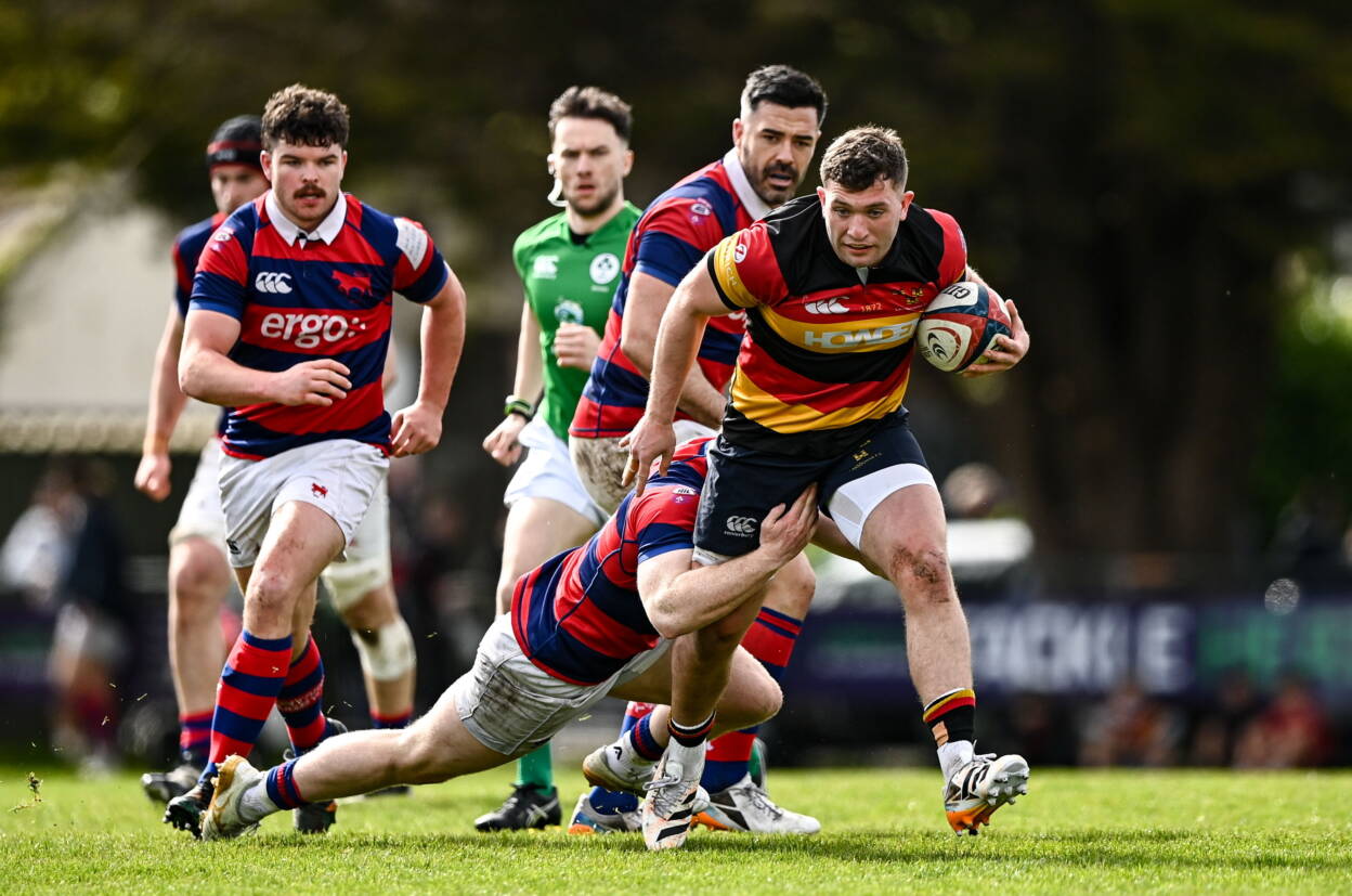 Lansdowne centre Harry O'Riordan is tackled by Clontarf and Leinster's Hugh Cooney