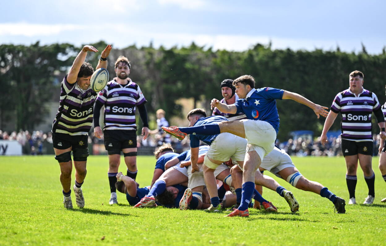 Terenure College captain Luke Clohessy charges down a kick from St. Mary's College scrum half Rob Gilsenan