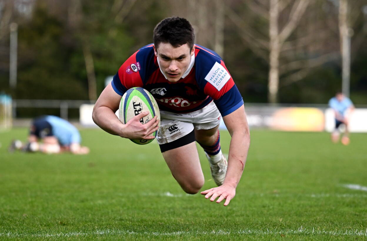 Dylan O'Grady dives over to score a try for Clontarf against UCD