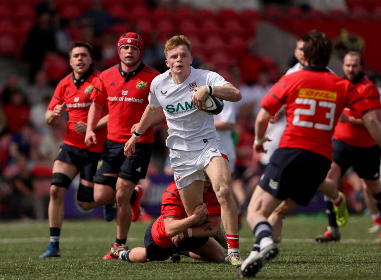 25 April 2026; Eddie Keys of Ulster is tackled by Ben Daly of Munster during the IRFU Men's Junior Interprovincials Round 1 match between Munster and Ulster at Sunday's Well RFC in Cork. Photo by Michael P Ryan/Sportsfile