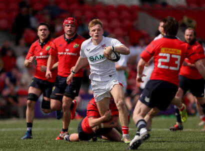 25 April 2026; Eddie Keys of Ulster is tackled by Ben Daly of Munster during the IRFU Men's Junior Interprovincials Round 1 match between Munster and Ulster at Sunday's Well RFC in Cork. Photo by Michael P Ryan/Sportsfile