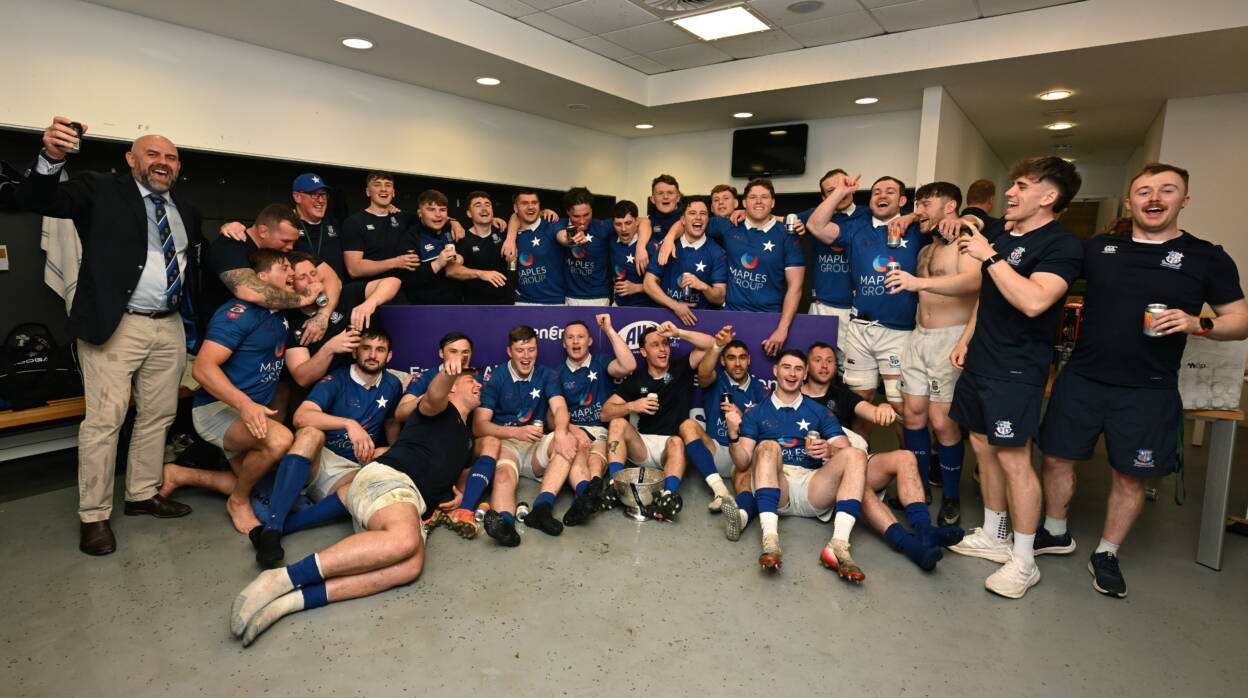 The St. Mary's College players celebrate with the trophy in the dressing room